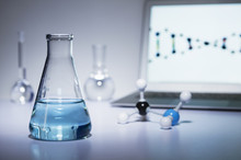 Chemistry Research. Erlenmeyer Flask Containing Colored Liquid, A Ball-and-stick Molecular Model And Laptop Computer