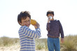 © Connect Images - Two young boys, playing with cup and string telephone