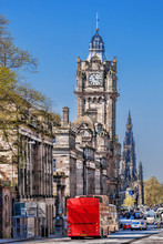 Edinburgh With Red Bus Against Clocktower In Scotland, UK