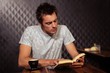 © WavebreakMediaMicro - Hipster man reading while drinking coffee