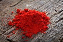 A Heap Of Paprika Powder, On Wooden Surface.