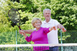 © sepy - Happy senior couple at tennis court