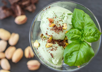 Wall Mural - Homemade organic green ice cream - Basil, pistachio, green tea, mint. A refreshing summer dessert. Selective focus
