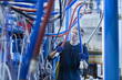© Connect Images - Factory technician inspecting network cables
