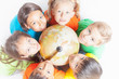 © petunyia - Group of international kids holding globe earth