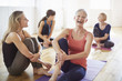 © Connect Images - Four women sitting on floor in pilates class