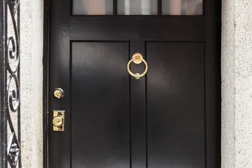 Wall Mural - Black front door, close up with brass door knocker