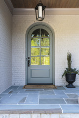 Wall Mural - Front door, close up view an arched door with reflection 