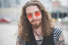 Portrait Of Young Male Hippy With Orange Sunglasses And Long Hair