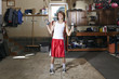 © Connect Images - Slim boy struggling to lift hand weights in garage