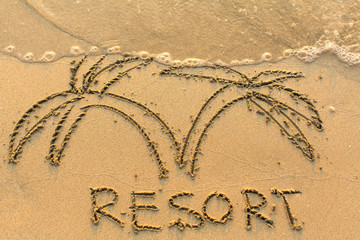 Wall Mural - Word Resort and palm trees - drawn by hand on a light-golden beach sand..