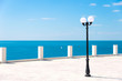 Street lamp on the sea promenade on clear sunny day