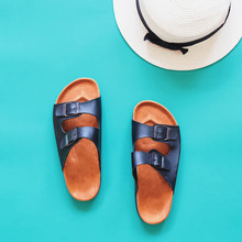 Leather Sandals With Panama Hat In Summertime Concept On Green B