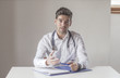 © GENETTICA - Frontal view of young doctor talking to the camera.
