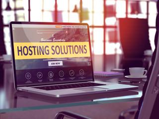 Wall Mural - modern workplace with laptop showing landing page with hosting solutions concept. toned image with s
