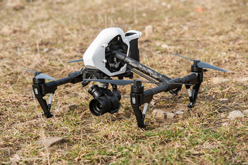 Wall Mural - drone quad copter on ground/white drone quad copter with digital camera on ground.selective focus