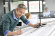 © goodluz - Architect working on project in office