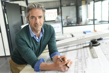 Portrait of smiling mature architect in office