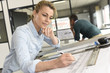 © goodluz - Architect woman working on drawing table