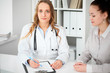 © rogerphoto - Doctor and  patient  sitting at the desk