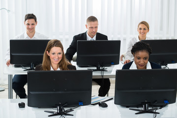 Businesspeople Working On Computers