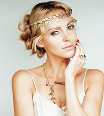 young blond woman dressed like ancient greek godess, gold jewelry close up isolated