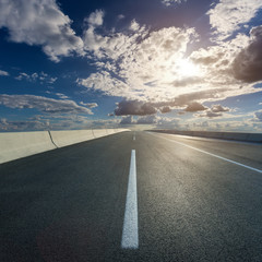 Wall Mural - driving on open road towards the setting sun