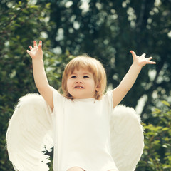 Wall Mural - Little happy boy dressed as angel