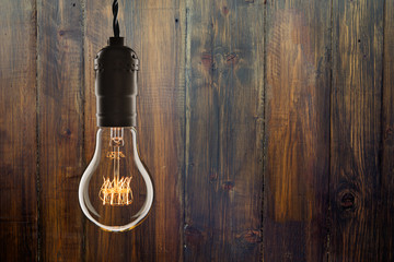 Wall Mural - Vintage incandescent Edison type bulb on wooden background