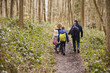 © Monkey Business - Family walking through a wood, back view, mum turning round