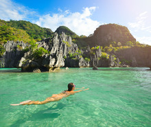 Happy Woman Swims In The Crystal Clear Water Near Of Islands