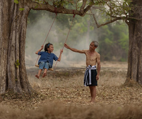 Happy family.Father and daughter are playing swing