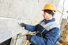 Facade Plasterer Sealing Joint Of Building Wall With Putty Mastic 