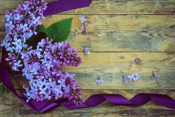 Wall Mural - bouquet of lilac branches with purple ribbon