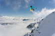 © Vasily Merkushev - Snowboard rider jumping on mountains. Extreme snowboard freeride sport.