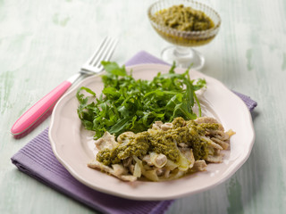 Wall Mural - stewed meat with pesto sauce and arugula salad, selective focus