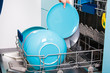 © fired - Woman empty out the dishwasher