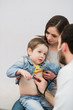 Pediatrician doctor examining boy lungs in focus