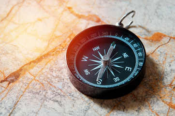 compass on marble stone background , vintage tone