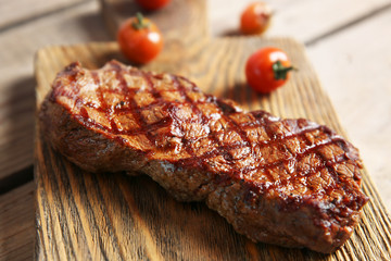 Sticker - Grilled steak on cutting board with cherry tomatoes, closeup