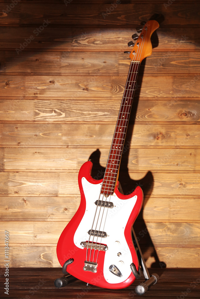 Electric guitar on dark lightened wooden background