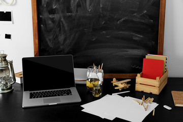 Sticker - Desktop with notebook and other items on blackboard background