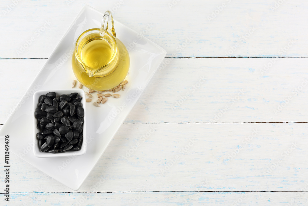 Sunflower seeds with oil on wooden table