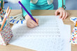 © Africa Studio - Little girl learning to write English letters at the table