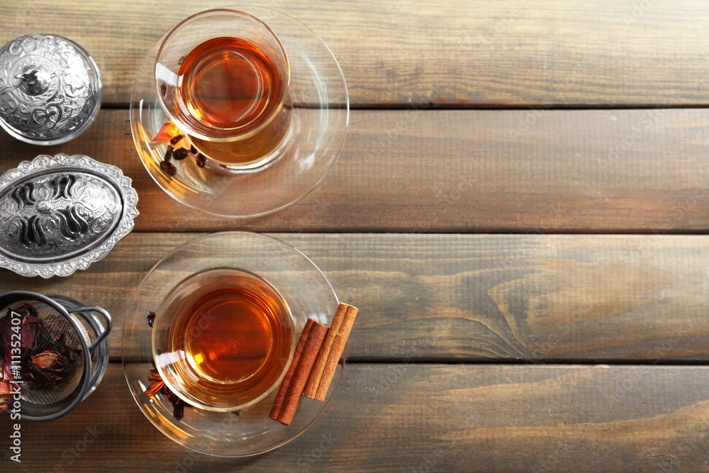Glass cups of tea on wooden  background