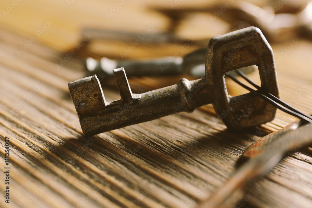 Bunch of old keys on wooden background