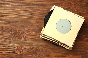 Wall Mural - Stack of old vinyl records on wooden background