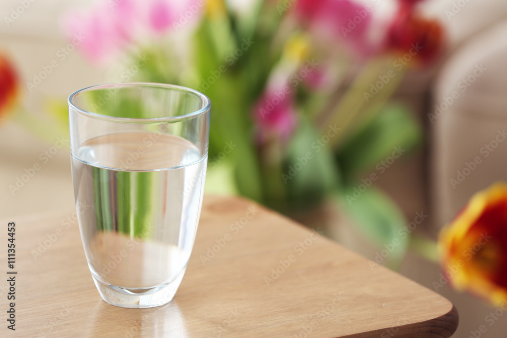 Glass of pure water on wooden table
