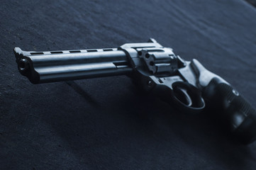 revolver on black background