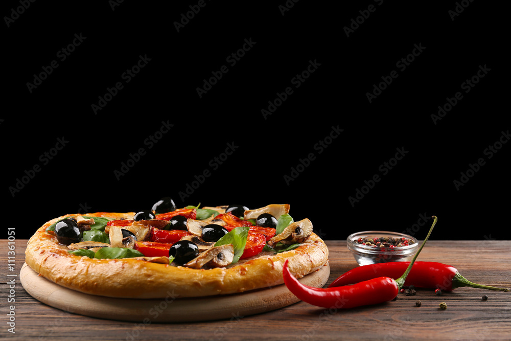 Delicious tasty pizza with ingredients on wooden table